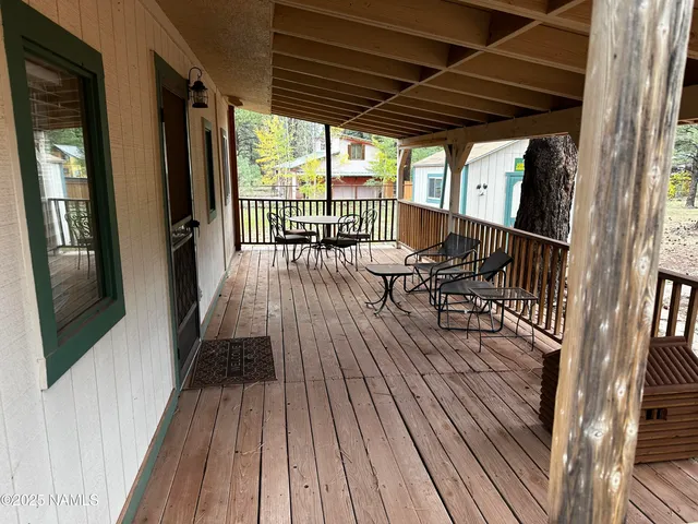 a view of balcony with chairs and wooden floor