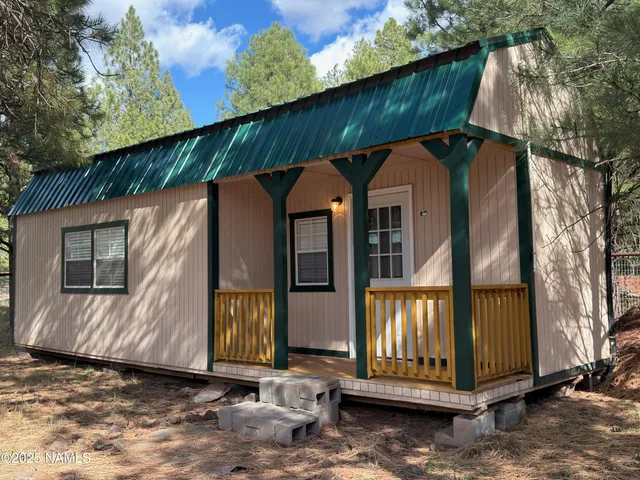 a view of a small house with roof deck