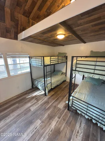 a bedroom with double bunk beds and a window