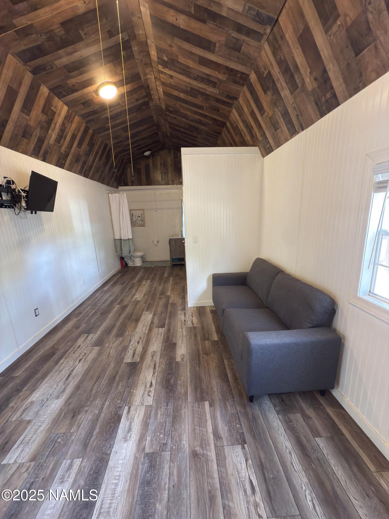 7261 East Long Bow Drive Williams, AZ 86046 - Photo 34 of 43 a view of a livingroom with wooden floor and staircase