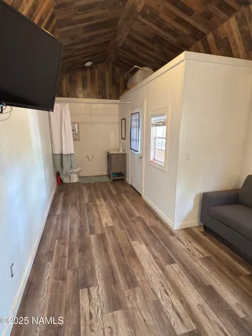 a view of livingroom with an empty space and wooden floor