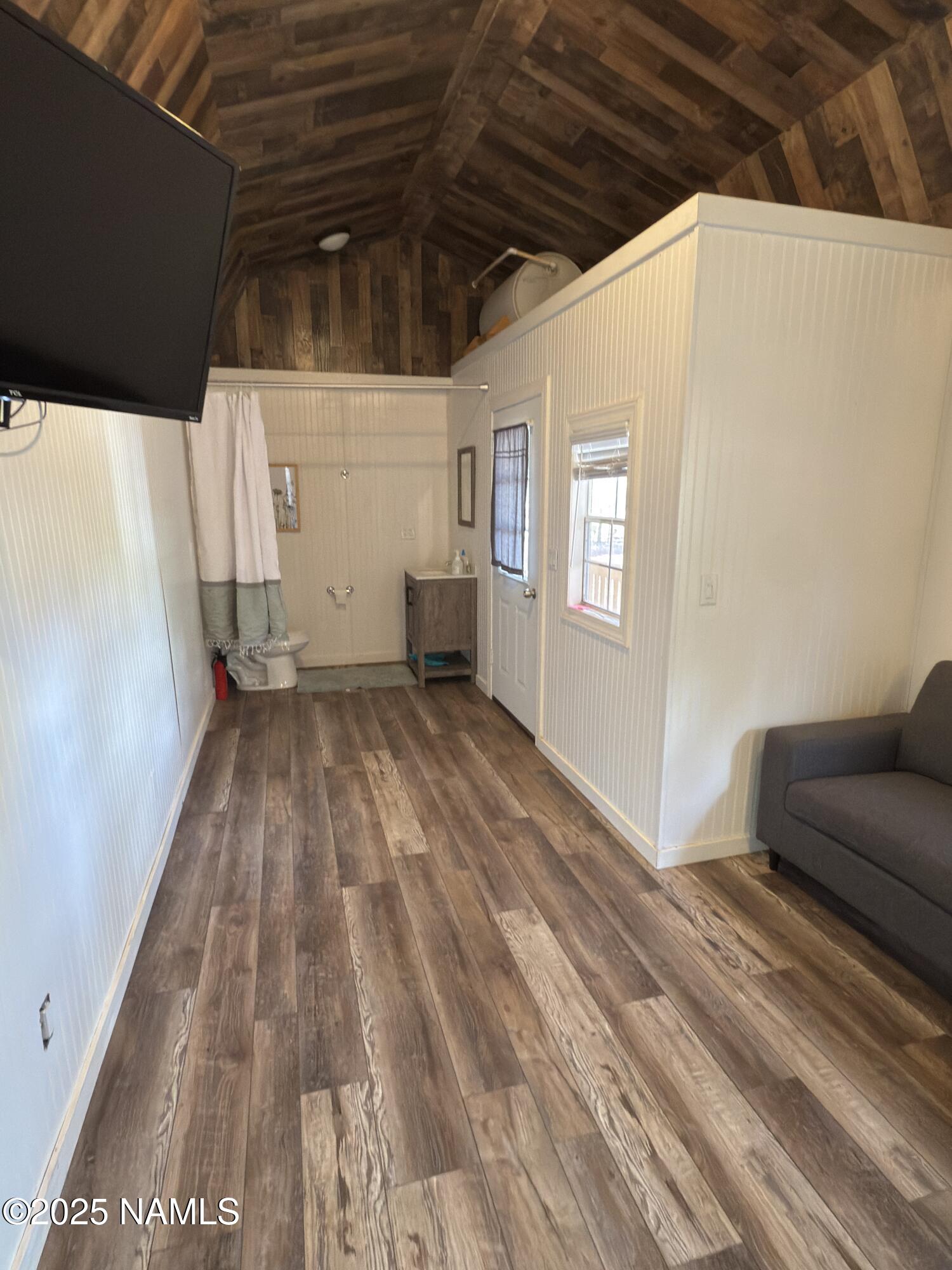 7261 East Long Bow Drive Williams, AZ 86046 - Photo 36 of 43 a view of livingroom with an empty space and wooden floor