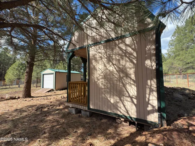 a backyard of a house with a large tree