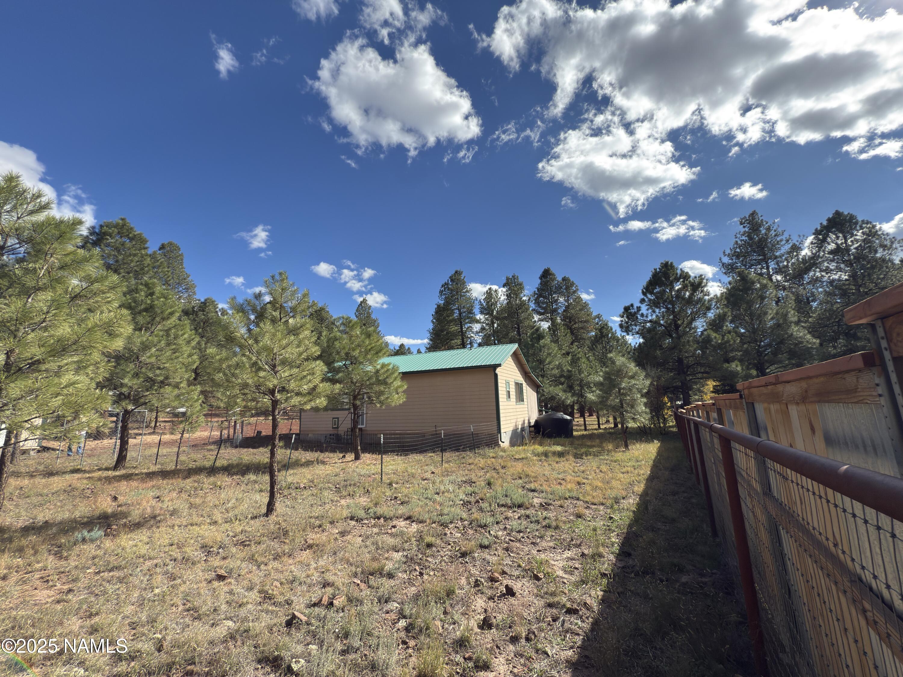 7261 East Long Bow Drive Williams, AZ 86046 - Photo 7 of 43 a view of a yard with wooden fence