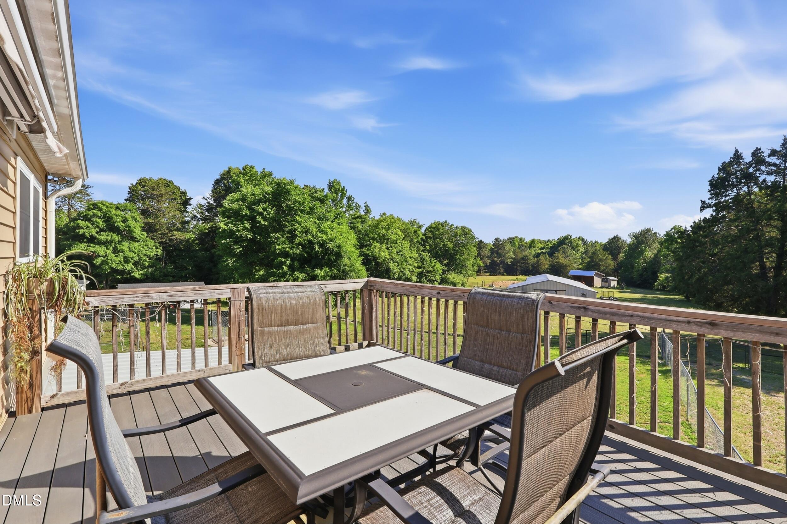 2631 South Jim Minor Road Haw River, NC 27258 - Photo 38 of 62 a view of a balcony with wooden floor and outdoor seating