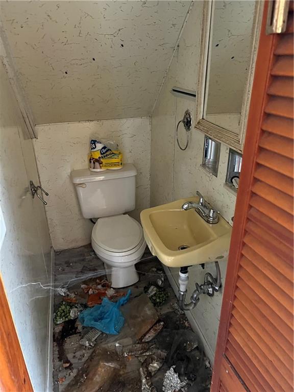 327 3rd Street Leechburg, PA 15656 - Photo 13 of 21 a bathroom with a toilet a sink and a mirror