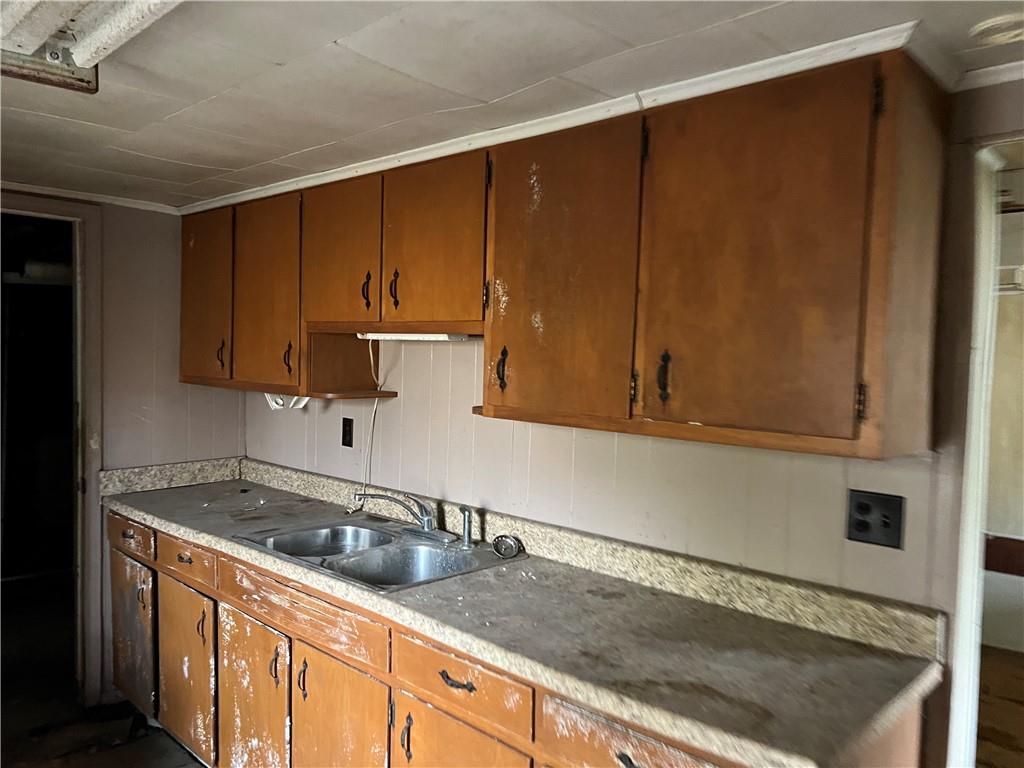 327 3rd Street Leechburg, PA 15656 - Photo 19 of 21 a kitchen with granite countertop a sink a stove and cabinets
