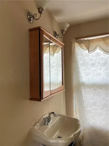 a bathroom with a sink and a window