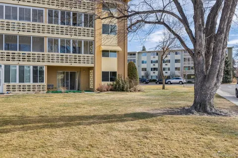 a front view of a building with a garden