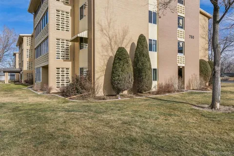 front view of a brick building with a yard