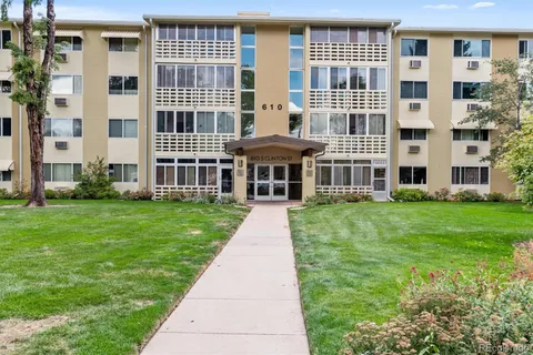 front view of a brick building with a yard