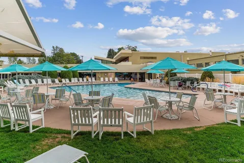 a view of a patio with table and chairs under an umbrella