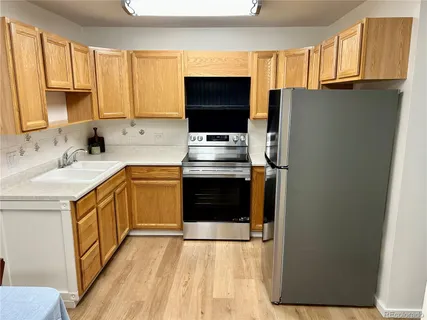 a kitchen with stainless steel appliances a stove sink and microwave