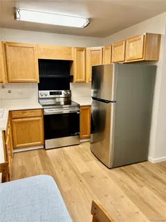a kitchen with stainless steel appliances granite countertop a refrigerator stove and microwave