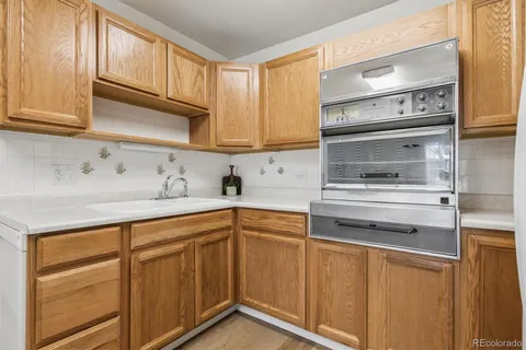 a kitchen with stainless steel appliances granite countertop a sink and cabinets