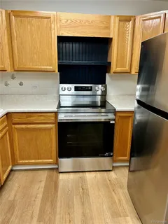 a stove top oven sitting inside of a kitchen