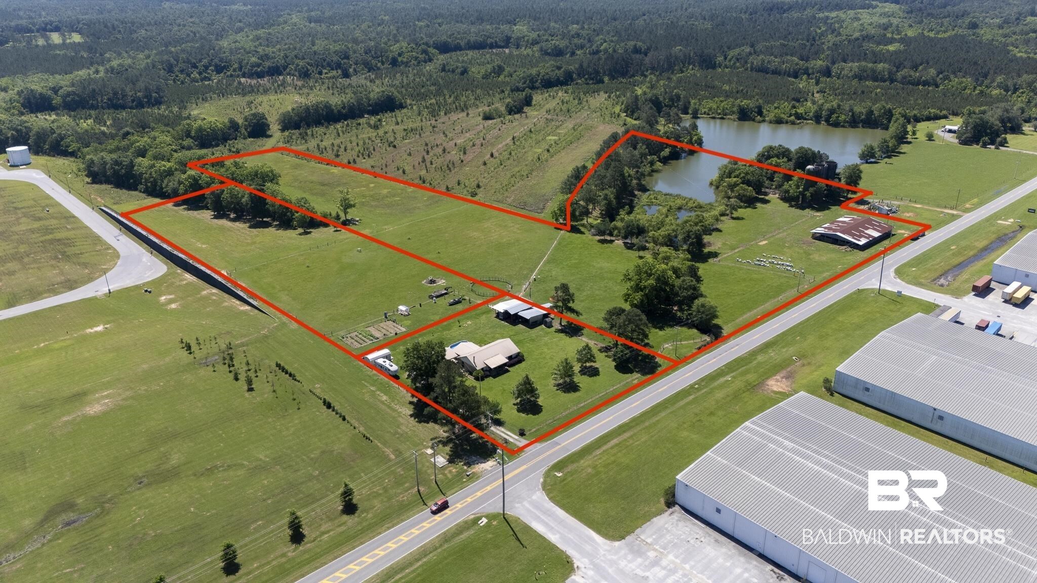 30580 County Road 49 Loxley, AL 36551 - Photo 3 of 32 Expansive property featuring a sizable pond, multiple cleared land parcels, and mature trees
