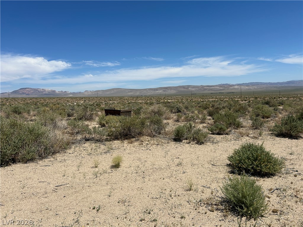 360 Mountain Creek Road Dyer, NV 89010 - Photo 8 of 23 Vast desert landscape stretches towards distant mountains under an expansive blue sky, offering an opportunity for development.