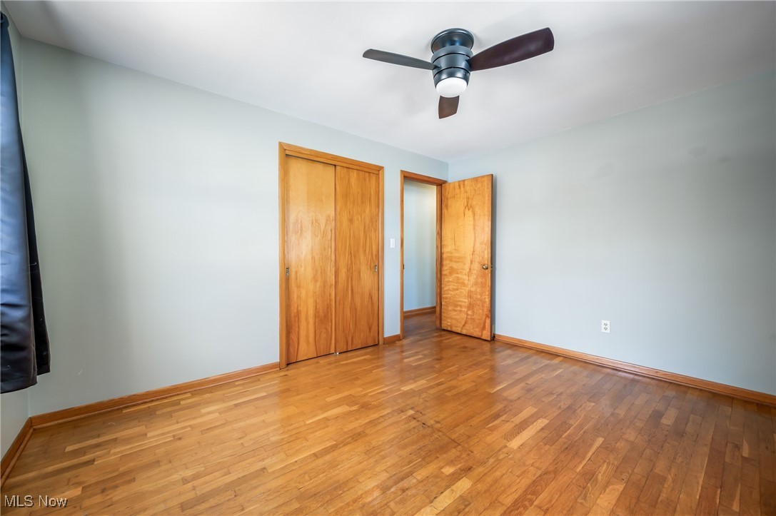 3210 Oser Road Norton, OH 44203 - Photo 34 of 47 Unfurnished bedroom with ceiling fan, light hardwood / wood-style floors, and a closet