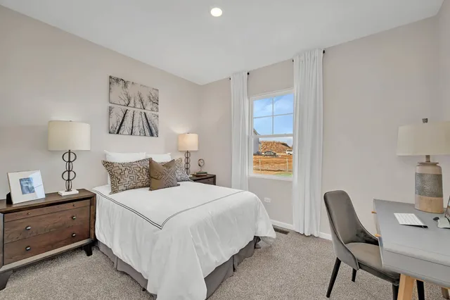 a bedroom with a bed and a desk