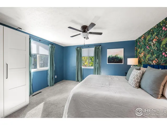 a living room with table chairs and wooden floor