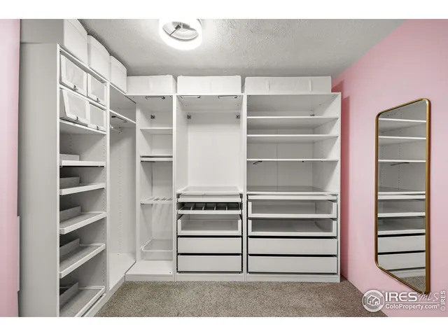 a view of a chair and table in backyard of the house