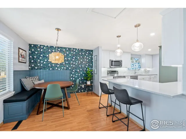 a living room with furniture a flat screen tv and kitchen view