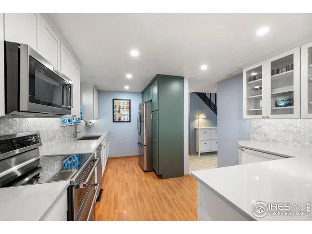 a kitchen with stainless steel appliances a stove a microwave sink and cabinets