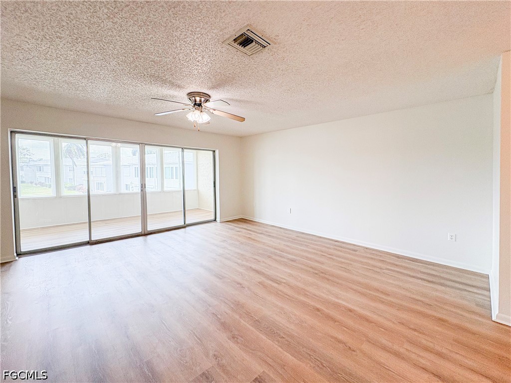 1830 Brantley Road, Unit I7 Fort Myers, FL 33907 - Photo 11 of 34 wooden floor in an empty room with a window