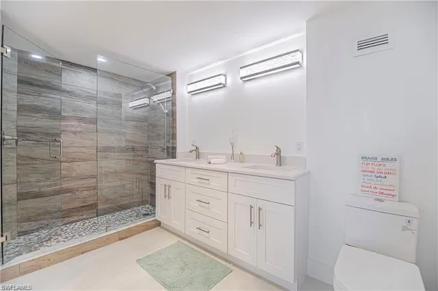 a bathroom with a shower sink vanity and mirror