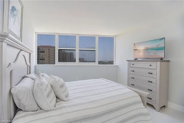 a bedroom with a bed and a television