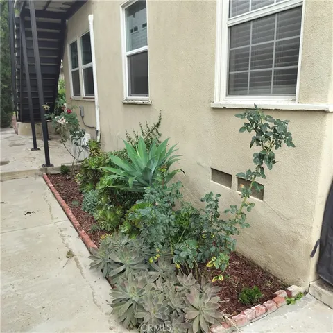 a house with a lot of flower plants