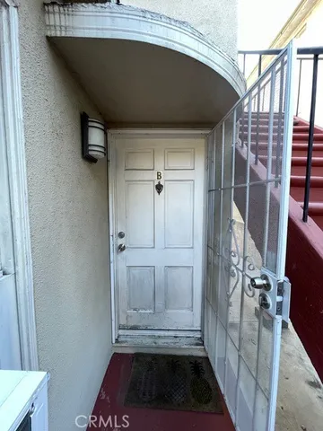 a view of a closet area with wooden floor
