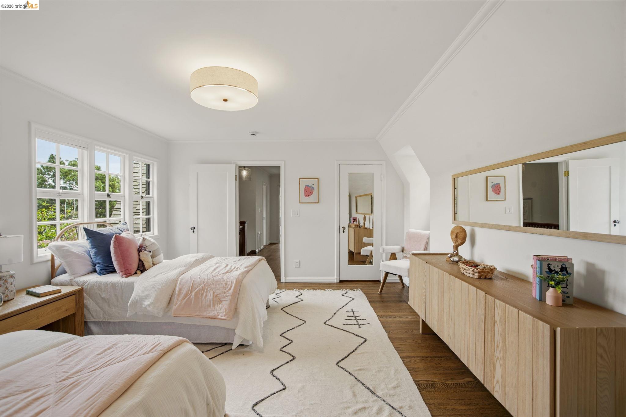 1087 Hubert Road Oakland, CA 94610 - Photo 33 of 67 Bright bedroom featuring hardwood flooring, white walls, and a multi-pane window