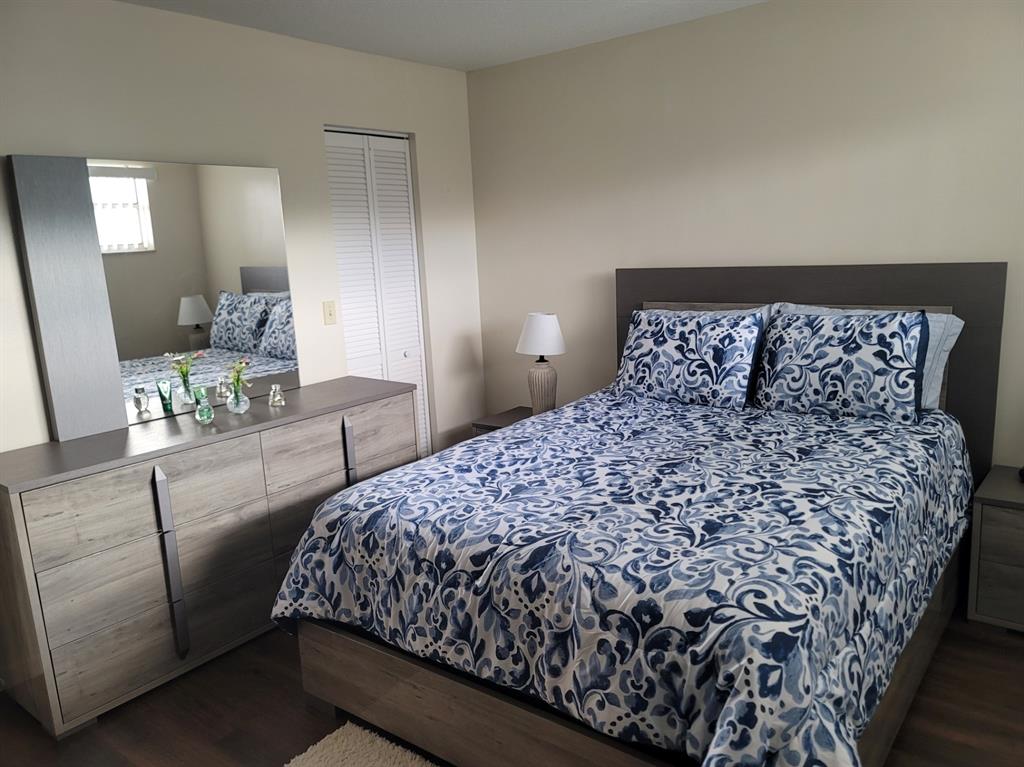 3774 Inverrary Boulevard, Unit P202 Lauderhill, FL 33319 - Photo 20 of 31 a bedroom with a large bed and a couch