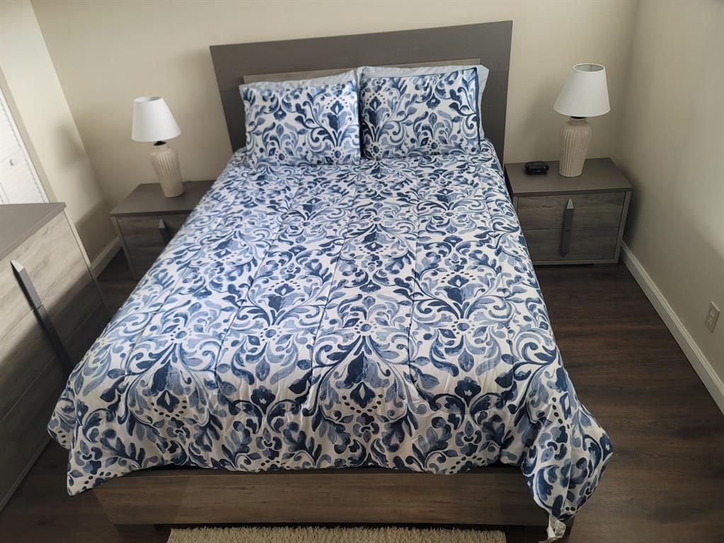 3774 Inverrary Boulevard, Unit P202 Lauderhill, FL 33319 - Photo 21 of 31 a large bed sitting in a bedroom next to a lamp