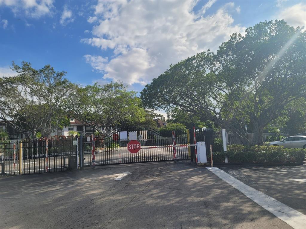3774 Inverrary Boulevard, Unit P202 Lauderhill, FL 33319 - Photo 31 of 31 a view of outdoor space with iron fence