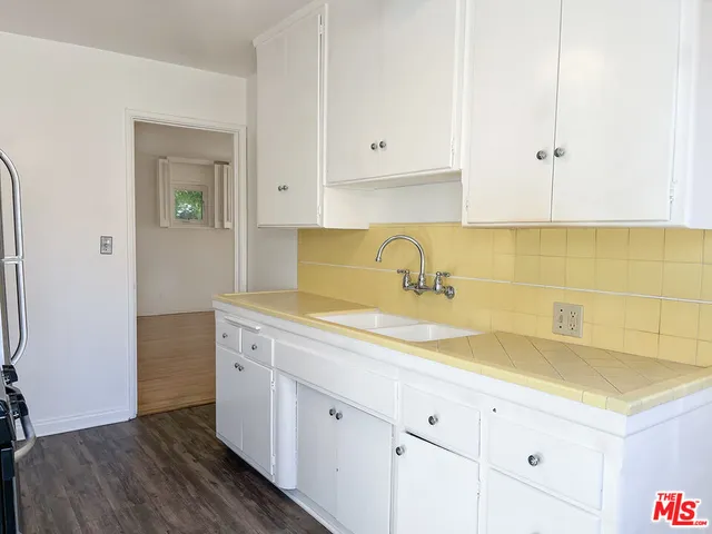 a kitchen with a sink and cabinets