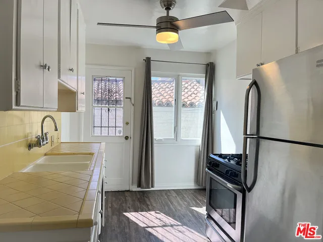 a kitchen with stainless steel appliances granite countertop a refrigerator and a sink
