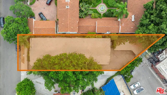 an aerial view of a house with a yard and lake view