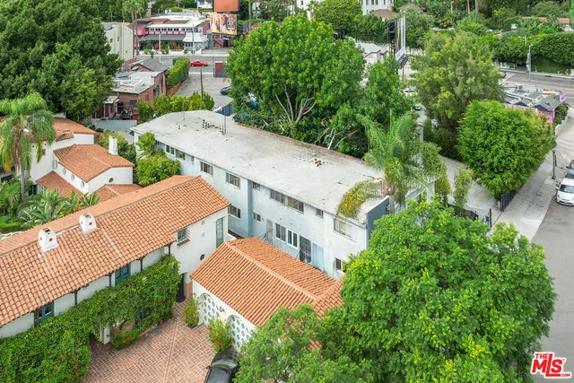 an aerial view of a house with a garden and yard