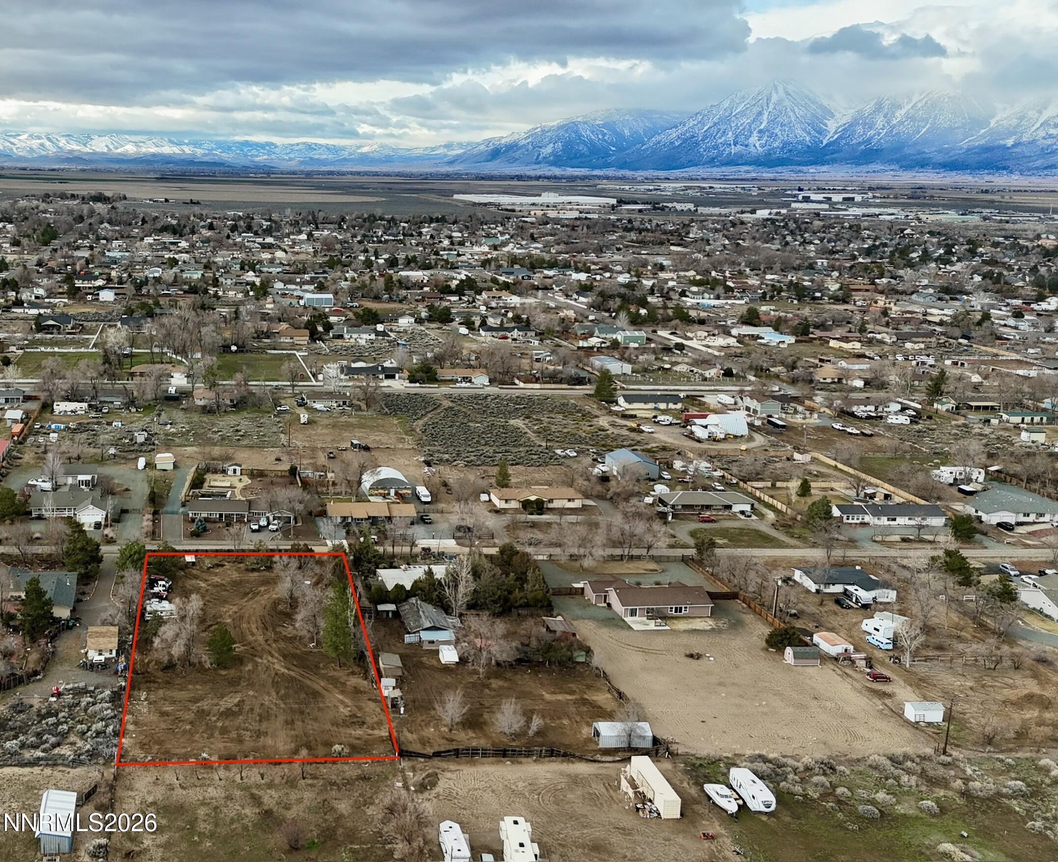 an aerial view of a house with a mountain
