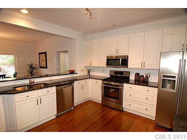 17516 Springwinds Drive Cornelius, NC 28031 - Photo 2 of 14 a kitchen with stainless steel appliances granite countertop a stove a sink and a refrigerator