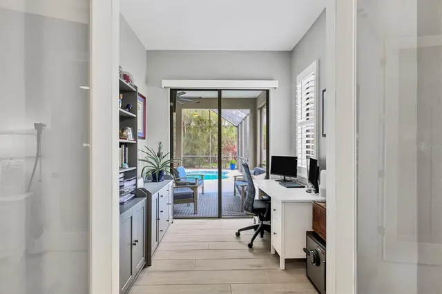 a living room with furniture and ceiling fan