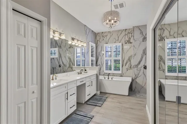a living room with furniture and floor to ceiling windows