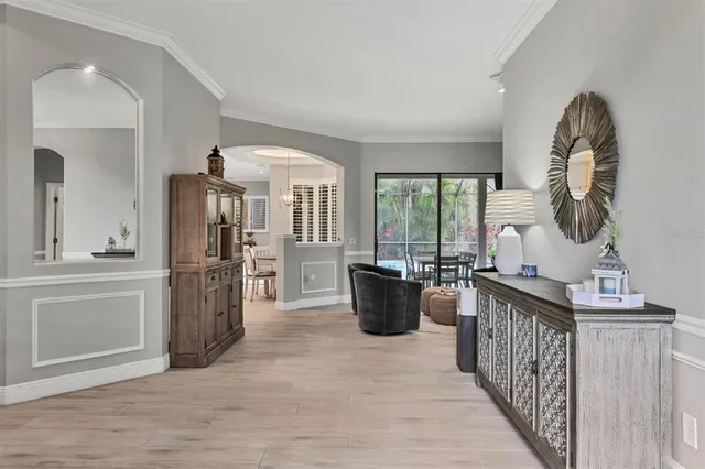 a living room with furniture a large window and a wooden floor