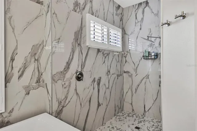 a view of a swimming pool with a patio and a yard