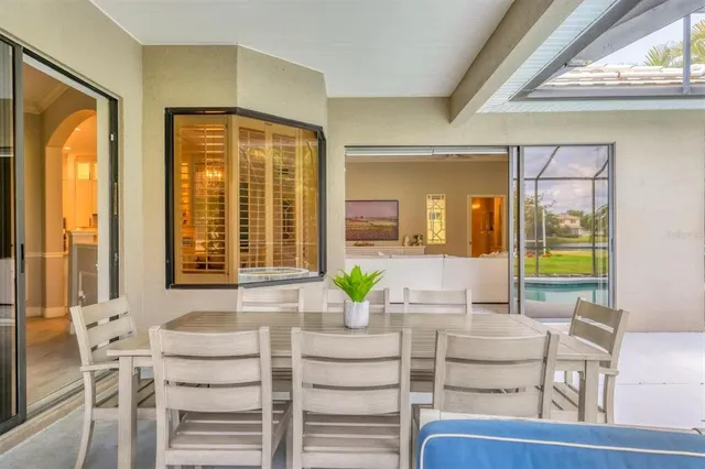 a view of a park with slide a bench and a large tree