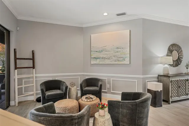a living room with furniture a chandelier and a window