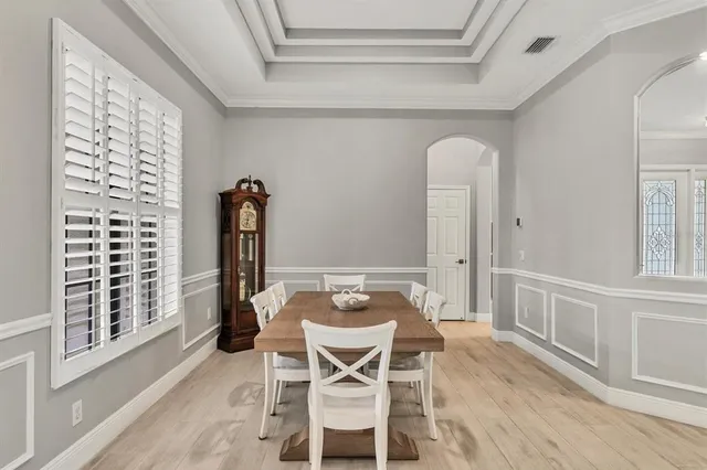 a view of a dining room with furniture large windows and wooden floor